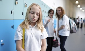 Schoolgirl being bullied in school corridor